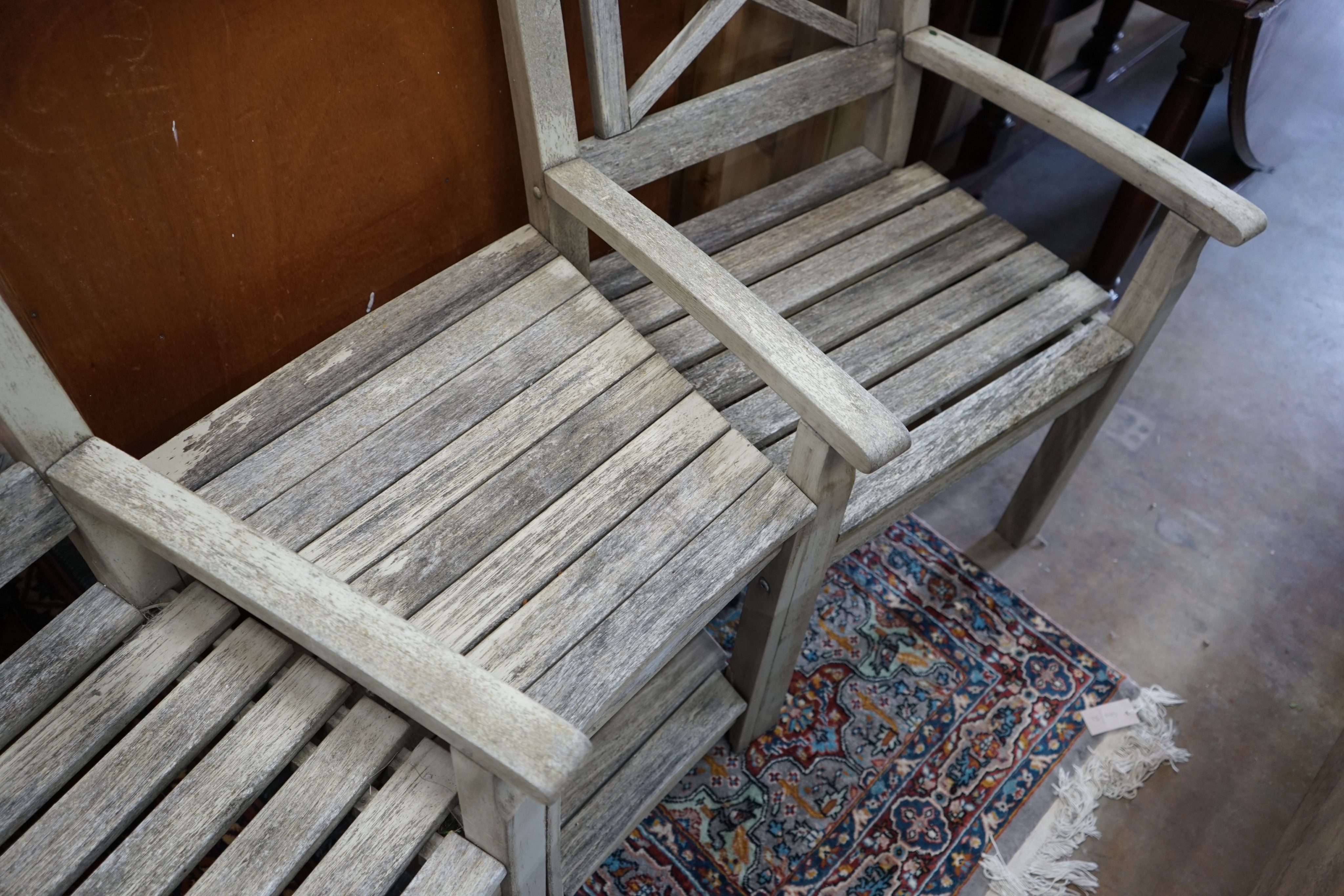 A weathered teak 'duet' garden seat, length 170cm width 52cm height 92cm